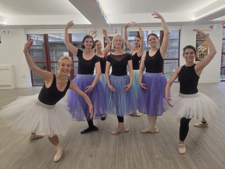 A group of seven dances posed.